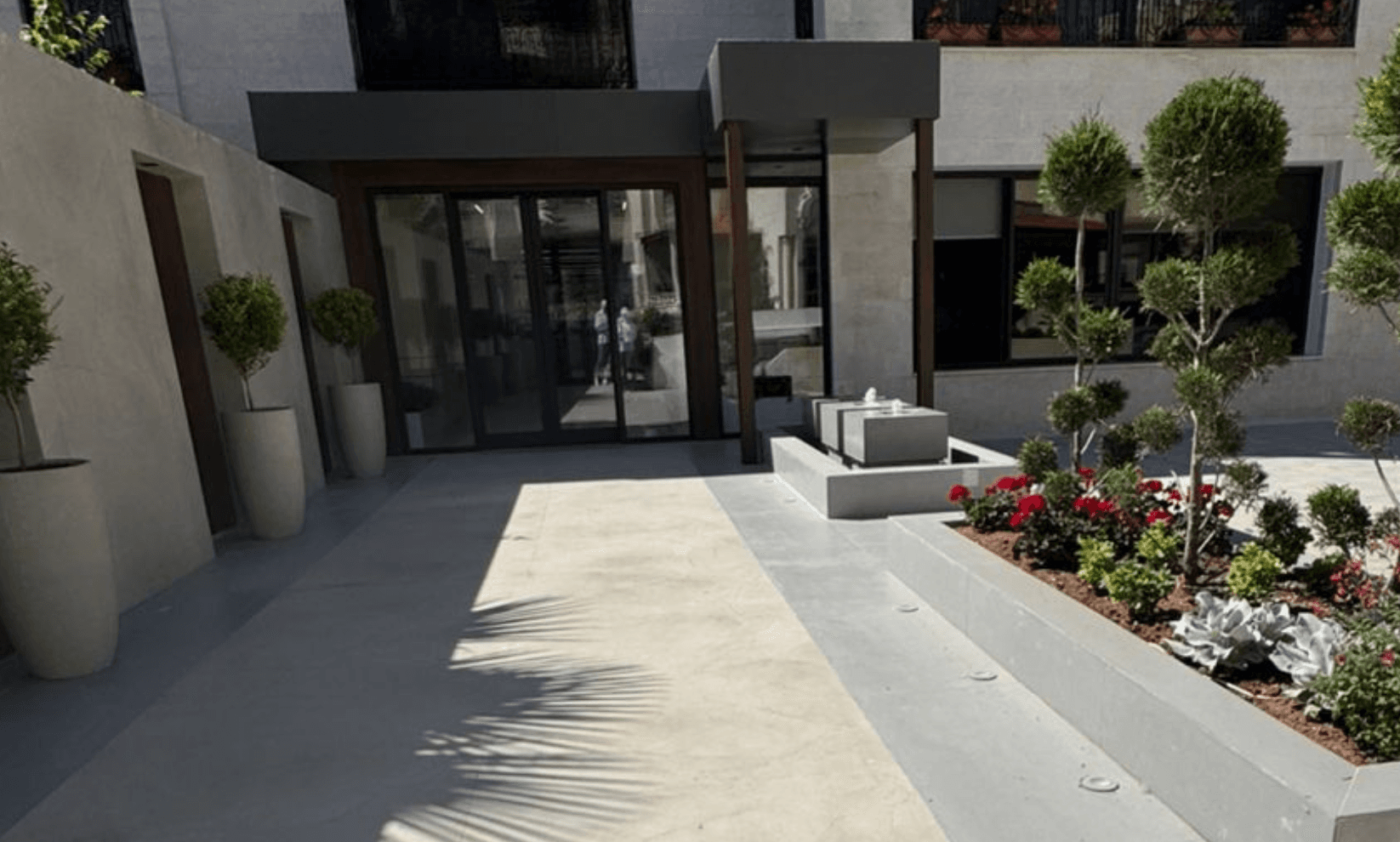 Entrance to the modern ZagTrader office with landscaping and a water feature